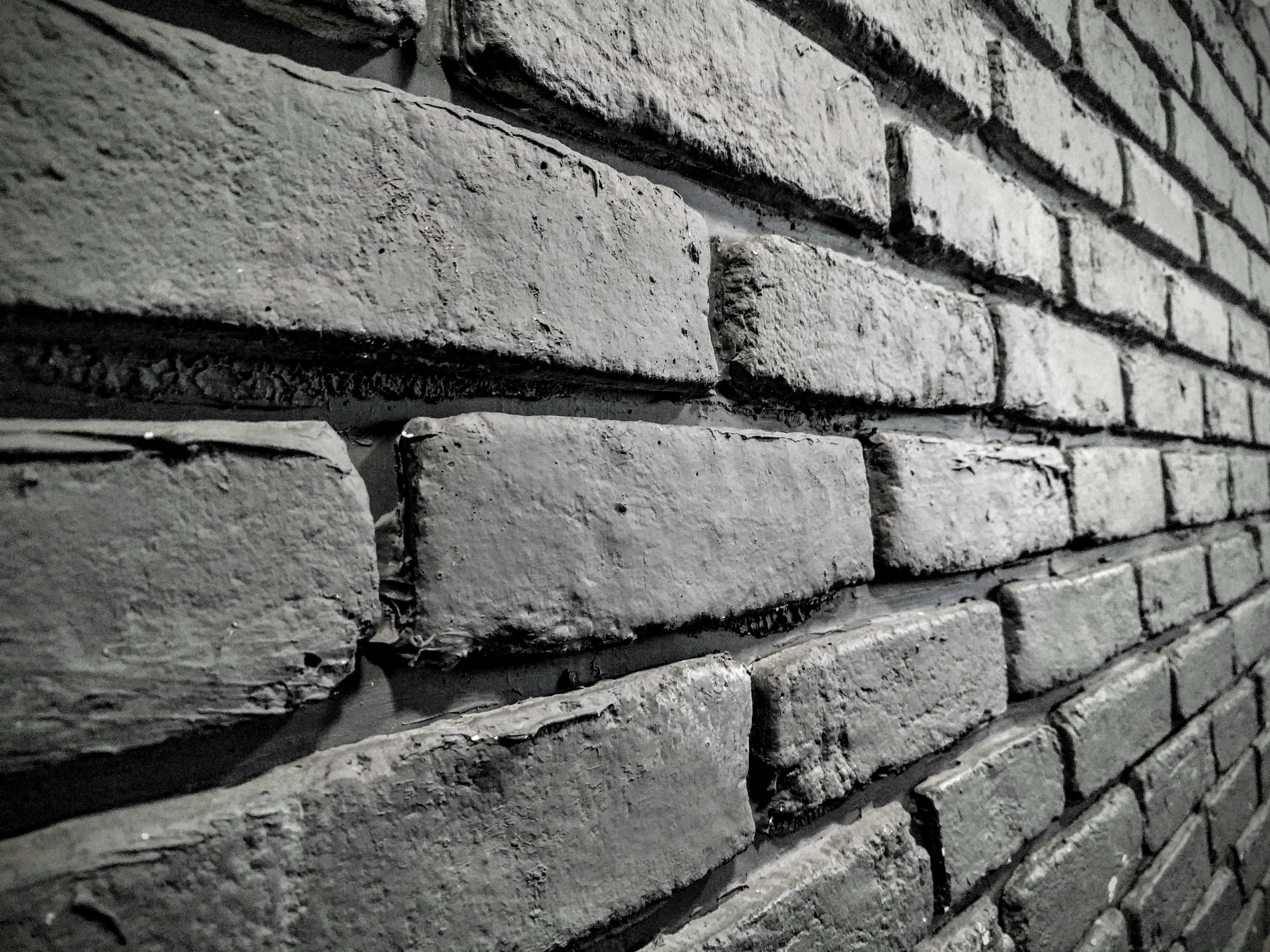 Greyscale close-up of an exterior brickwork wall