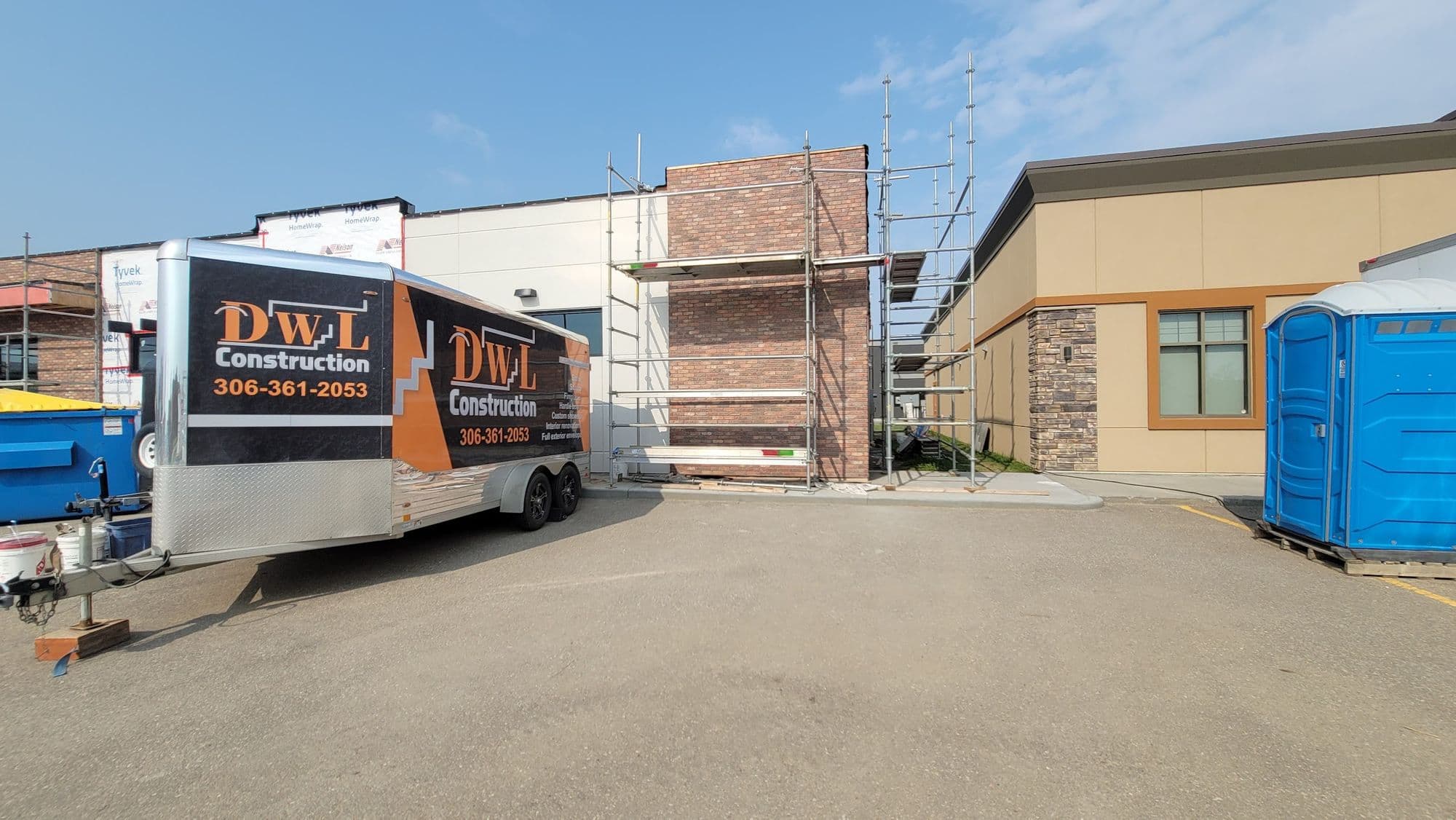 DWL Construction trucks and trailer parked at a Lloydminster job site