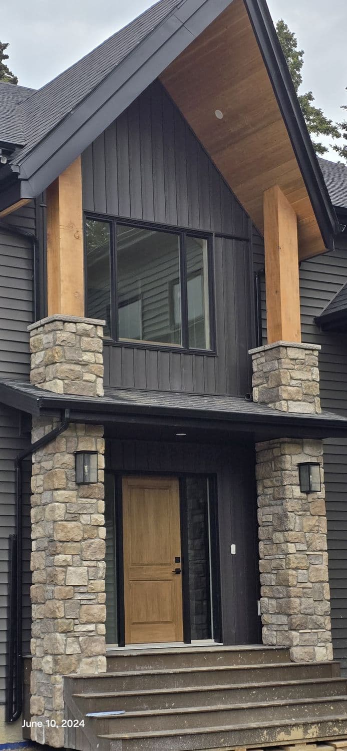Stone-wrapped entry columns under a timber-accented gable