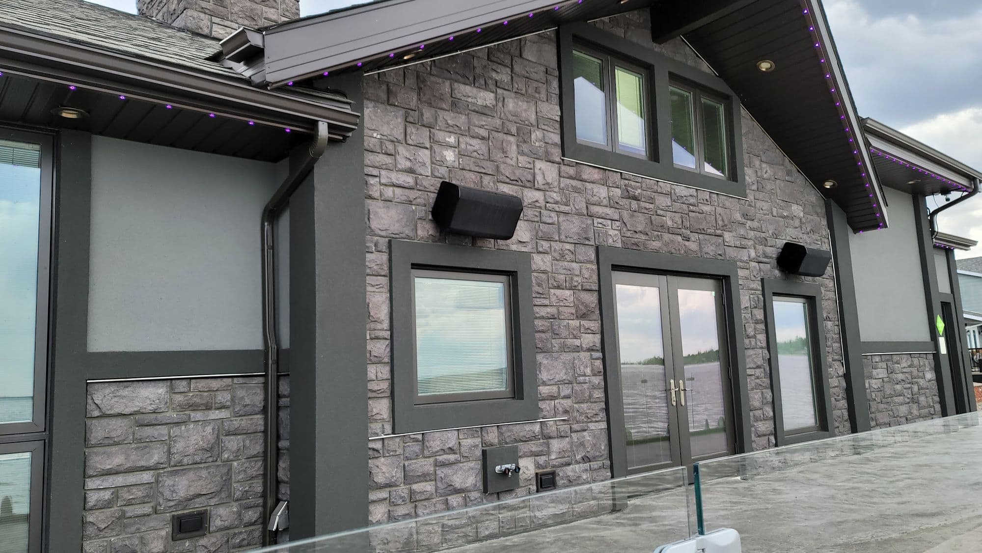 Stone and stucco exterior on a two-storey lake house near Lloydminster