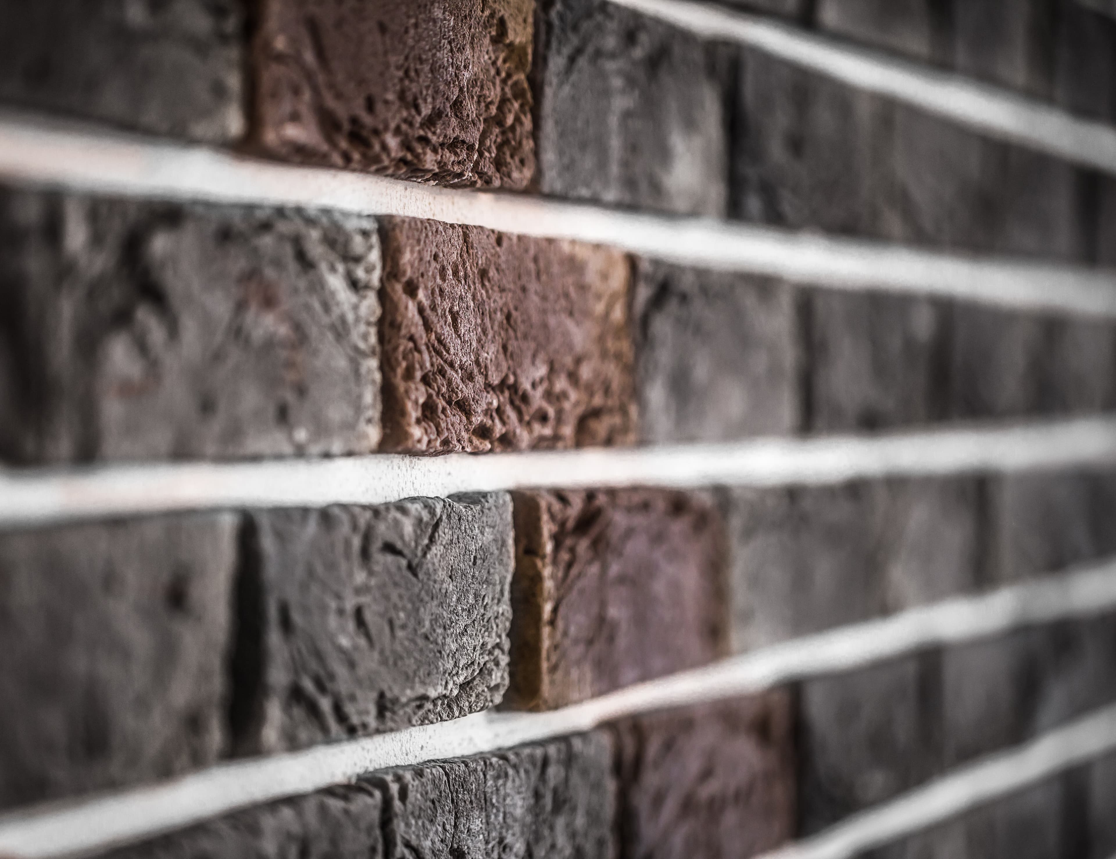 Dramatic close-up of a brick wall in raking light