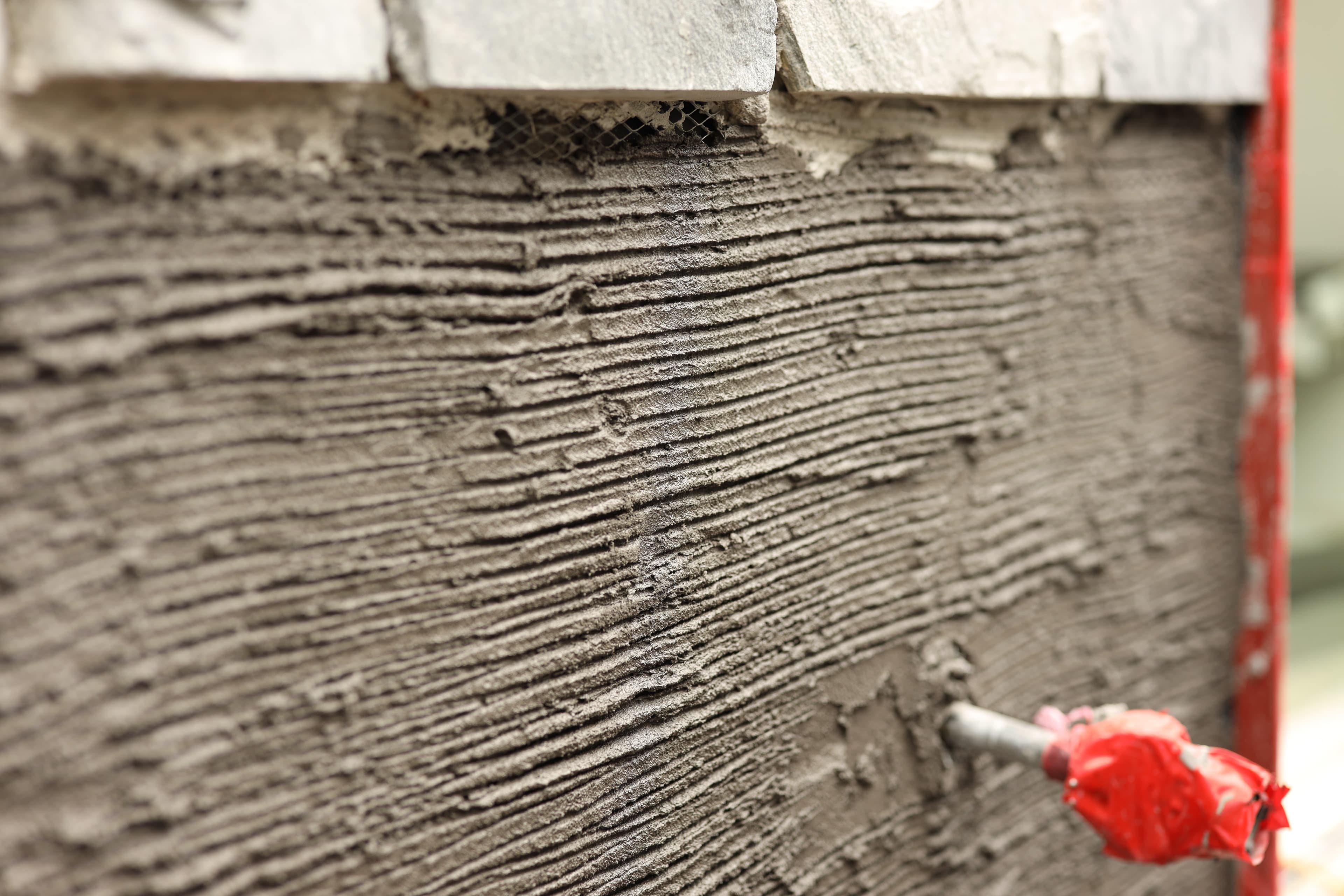 Close-up of fresh stucco/parging finish on an exterior wall